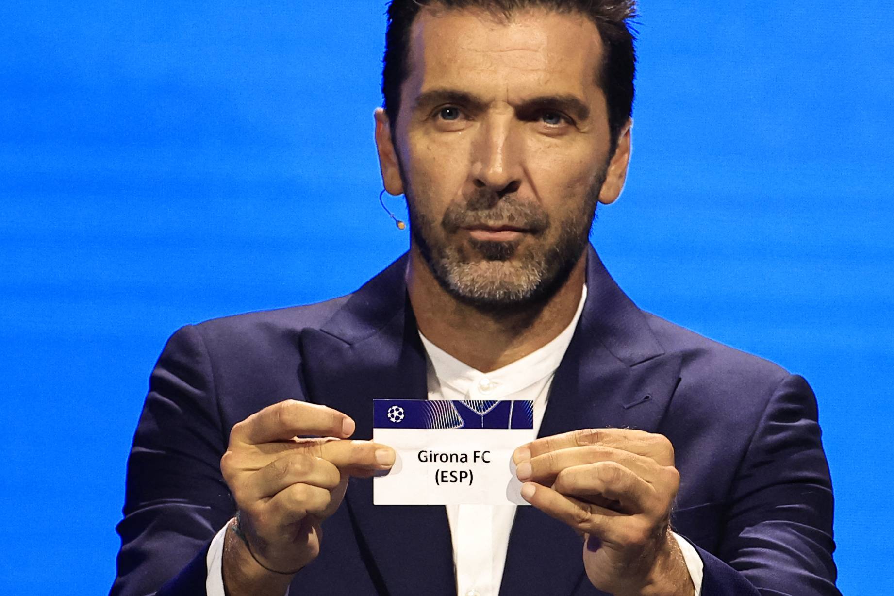 Italy's former goalkeeper Gianluigi Buffon shows the paper slip of Girona FC (ESP) during the group stage of the 2024-2025 UEFA Champions League football tournament, at the Grimaldi Forum in Monaco on August 29, 2024. (Photo by Valery HACHE / AFP)